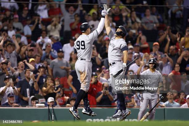 Aaron Judge of the New York Yankees celebrates with Giancarlo Stanton after hitting a home run against the Boston Red Sox during the eighth inning at...