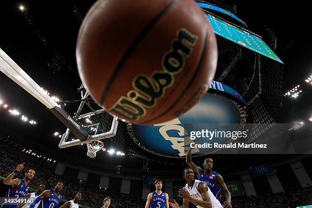 Doron Lamb of the Kentucky Wildcats looses the ball in front of Tyshawn Taylor of the Kansas Jayhawks in the first half in the National Championship...