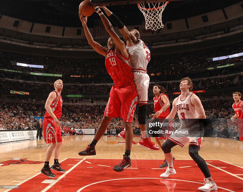 Houston Rockets Marcus Marcus Camby of the Houston Rockets grabs a rebound from Taj Gibson ...
