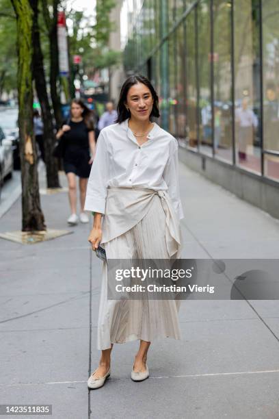 Eva Chen wearing white button shirt, beige pleated skirt outside Brandon Maxwell on September 13, 2022 in New York City.