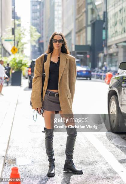 Model wearing beige oversized blazer outside Brandon Maxwell on September 13, 2022 in New York City.