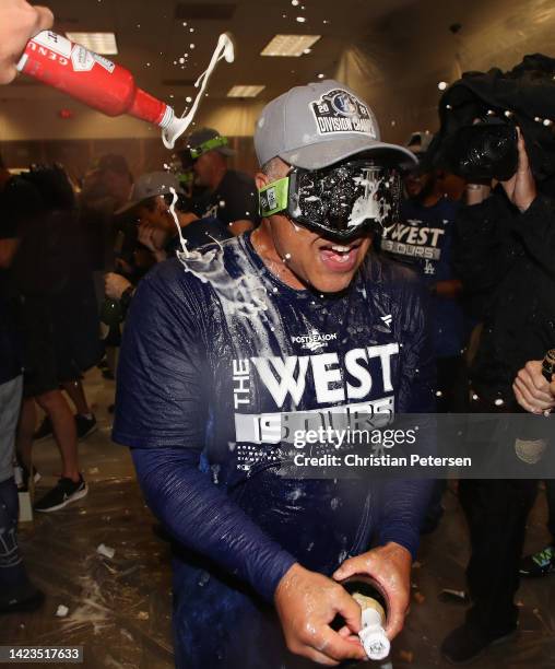 Manager Dave Roberts of the Los Angeles Dodgers celebrates with teammates in the locker room after defeating the Arizona Diamondbacks at Chase Field...