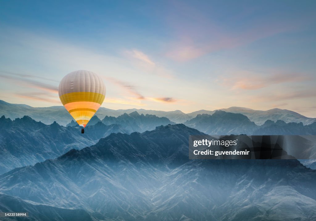 Hot air balloon flying over rocky mountains in TURKEY