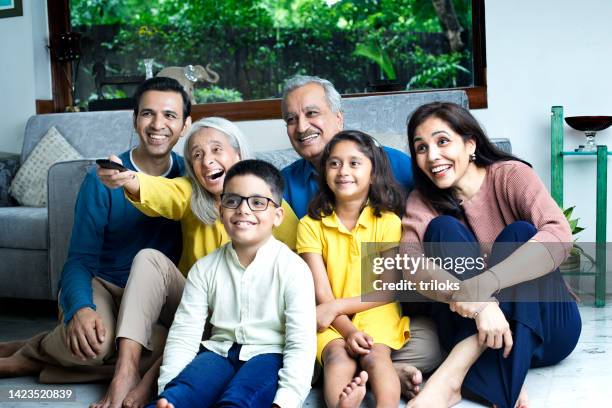 multi generation family watching tv at home - indian kids watching tv stock pictures, royalty-free photos & images