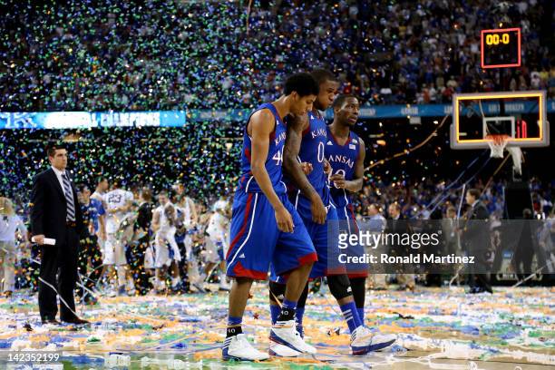 Kevin Young, Thomas Robinson and Tyshawn Taylor of the Kansas Jayhawks walk off the court after losing to the Kentucky Wildcats 67-59 in the National...