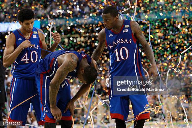 Kevin Young, Thomas Robinson and Tyshawn Taylor of the Kansas Jayhawks react after losing to the Kentucky Wildcats 67-59 in the National Championship...