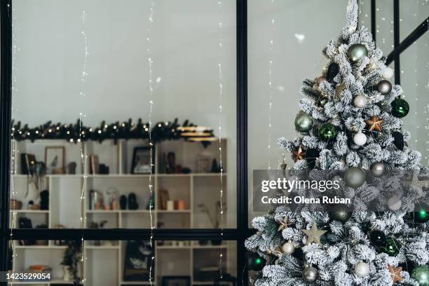 new year tree against glass partition and xmas room. - conifer cone stock pictures, royalty-free photos & images