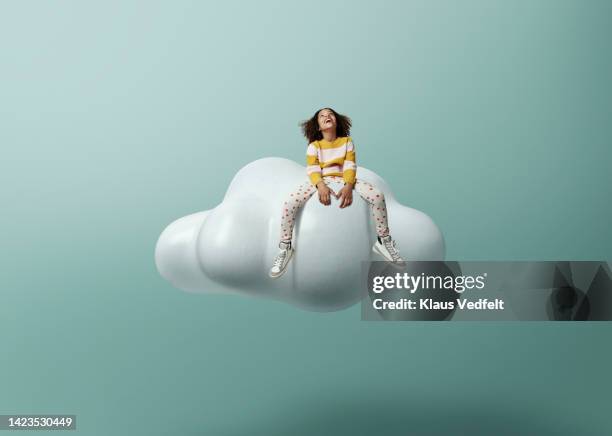 girl laughing while sitting on cloud - chaussures grises photos et images de collection