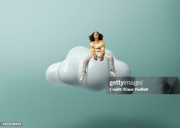 girl laughing while sitting on cloud - kid creativity stock pictures, royalty-free photos & images