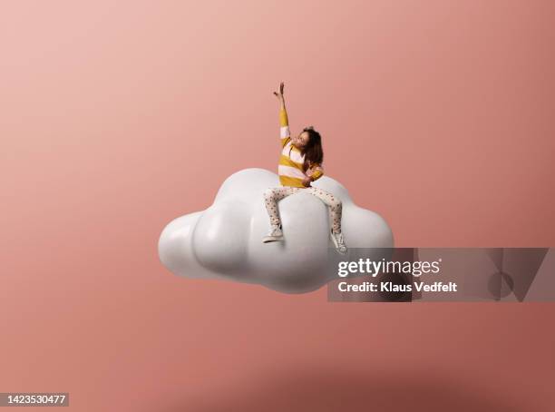 girl with hand raised gesturing on cloud - kid reaching stock pictures, royalty-free photos & images