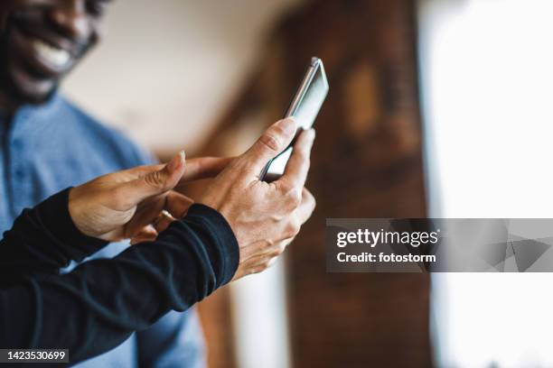 cut out shot of woman showing memes to her partner via smart phone - call us stock pictures, royalty-free photos & images