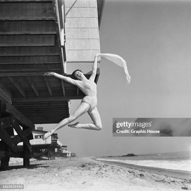 American actress and singer Shirley MacLaine, wearing a leotard, performs an Italian pas de chat outside her beach front home, in Los Angeles,...