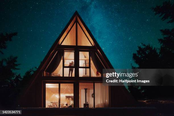 outdoor view of designed mountain cottage. - home night stock pictures, royalty-free photos & images