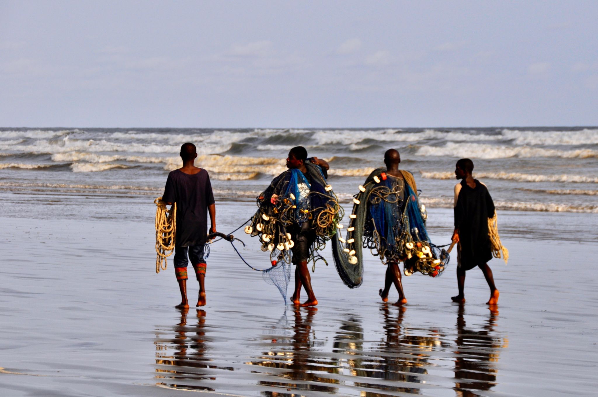 Four Fishermen Are Walking On The Beach Four Fishermen Are Walking On The Beach