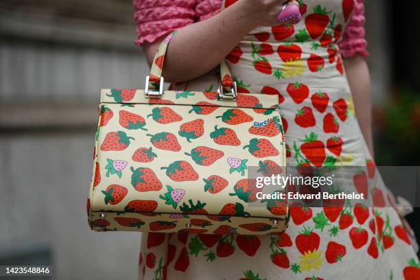 Guest wears a pink ruffled short sleeves t-shirt, a white with red and green strawberries print pattern square neck / long dress, a matching white...