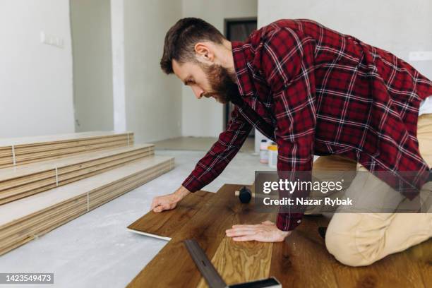 a man lying a parquet floor - parket stockfoto's en -beelden