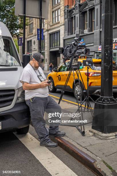 television camera man waiting with his equipment - film crew outside stock pictures, royalty-free photos & images