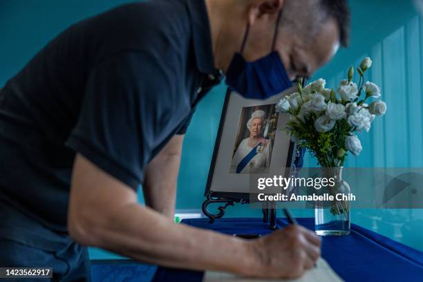 Man signs a book of condolence on the death of Queen Elizabeth II at British Office Taipei as the world reacts to the passing of Queen Elizabeth II...