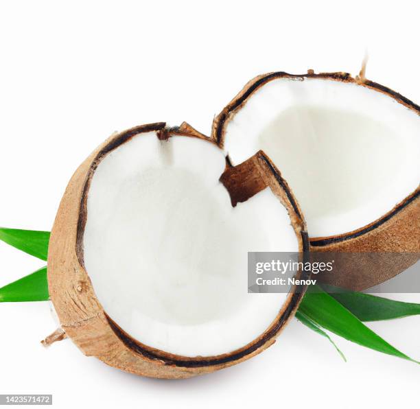 broken coconut with green leaves on white background - 2 coconut drinks ストックフォトと画像