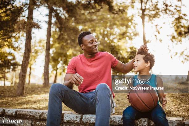 father and son spending time together outdoors. - park family sunset stock pictures, royalty-free photos & images