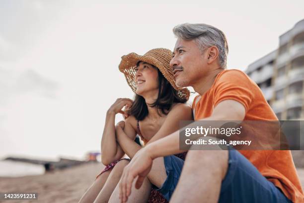 japanese couple looking on a horizon - europe asian culture stockfoto's en -beelden