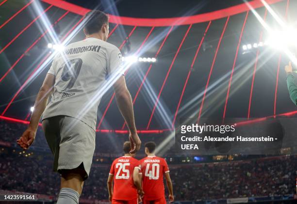 Robert Lewandowski of Barcelona enters the field of play with Thomas Müller of München and his team mate Noussair Mazraoui for the UEFA Champions...