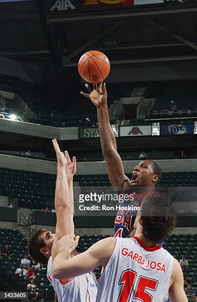 Elton Brand of the United States shoots over Felipe Reyes and Jorge Garbajosa of Spain during the classification round of the World Basketball...