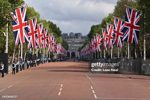 Union flags are seen lining The Mall as Metropolitan Police officers gather ahead of the procession for the Lying-in State of Queen Elizabeth II on...