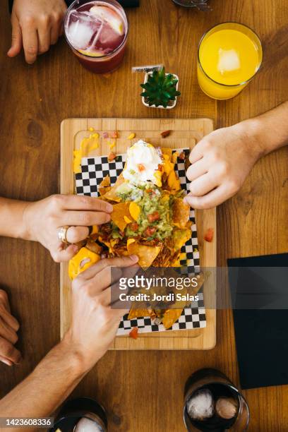 people eating nachos - cordoba spain stock pictures, royalty-free photos & images