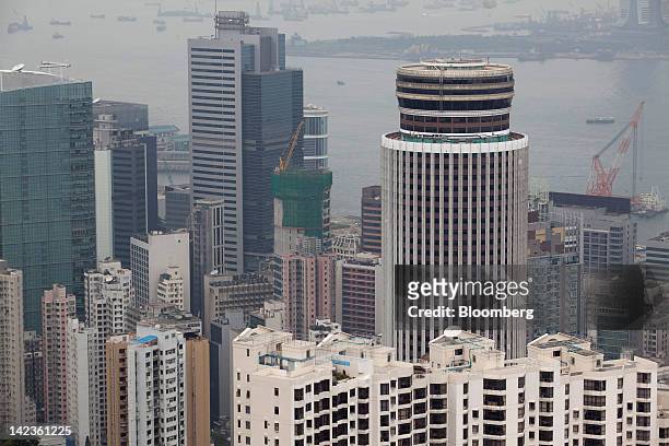 The Hopewell Centre, right, stands surrounded by residential and commercial buildings in Hong Kong, China, on Friday, March 30, 2012. Hong Kong's...