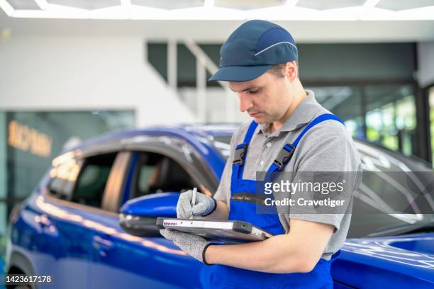 professional car inspector check and input data after checking routine maintenance by using a computer tablet in the auto repair garage. routine maintenance concepts. - auto detailing stock pictures, royalty-free photos & images