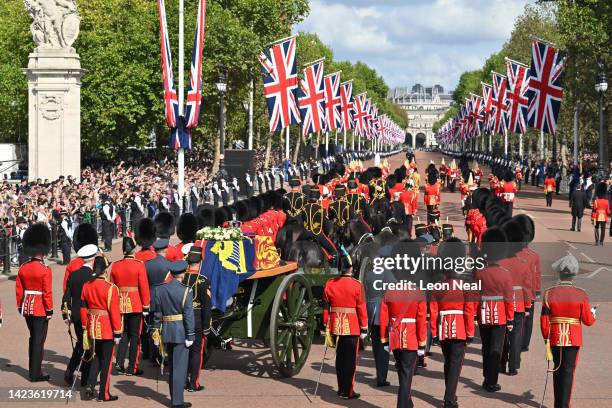 The Queen’s funeral cortege makes its way along The Mall from Buckingham Palace during the procession for the Lying-in State of Queen Elizabeth II on...