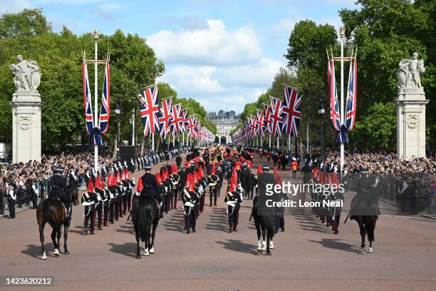 The Queen’s funeral cortege makes its way along The Mall from Buckingham Palace during the procession for the Lying-in State of Queen Elizabeth II on...