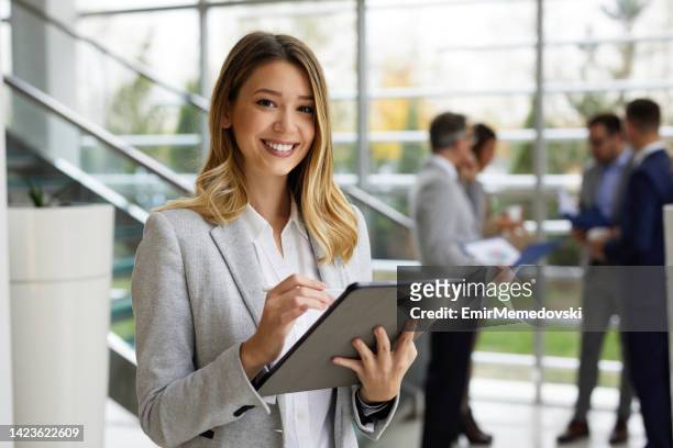 young businesswoman with digital tablet at work - holding ipad stock pictures, royalty-free photos & images