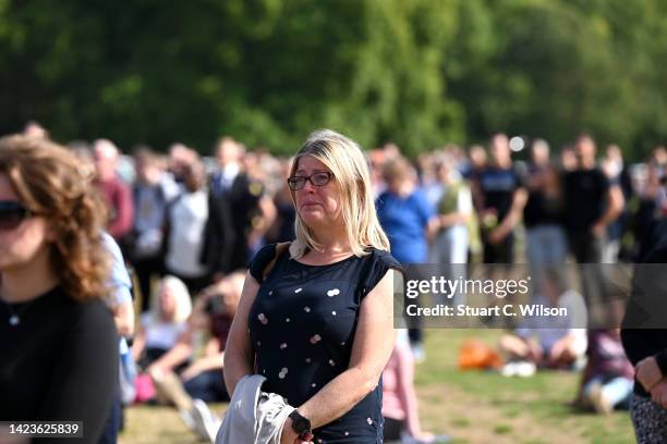 Tearful mourner watch's the procession for the Lying-in State of Queen Elizabeth II at the Hyde Park screening site on September 14, 2022 in London,...