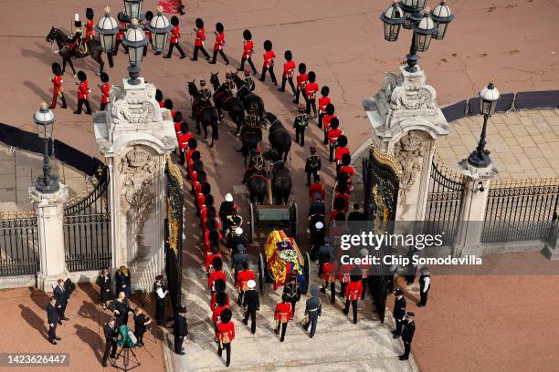 Queen Elizabeth II's flag-draped coffin is taken in procession on a Gun Carriage of The King's Troop Royal Horse Artillery through the gates of...