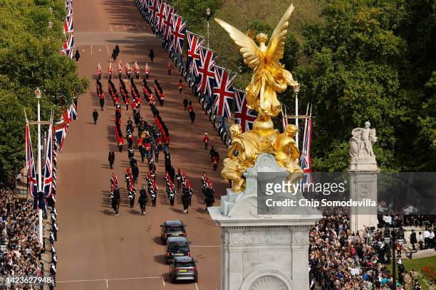 Members of the public line the Queen Victoria Memorial and the Mall as King Charles III and members of the royal family walk with Queen Elizabeth...