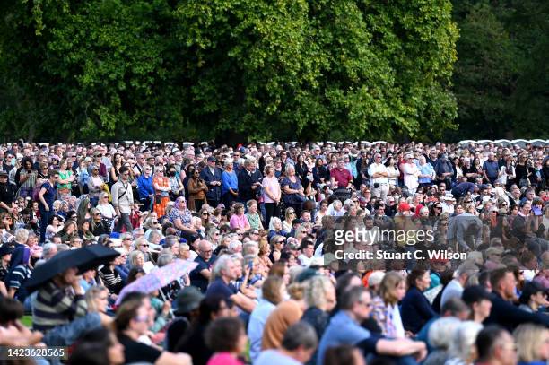 Mourners watch the procession for the Lying-in State of Queen Elizabeth II at the Hyde Park screening site on September 14, 2022 in London, England....