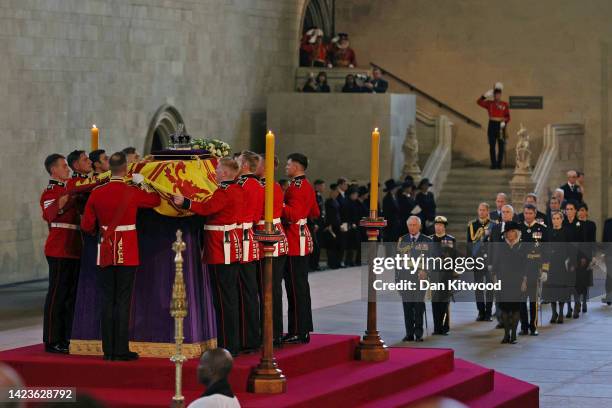 General view as King Charles III, Princess Anne, Princess Royal and Camilla, Queen Consort view the coffin carrying Queen Elizabeth II being laid to...