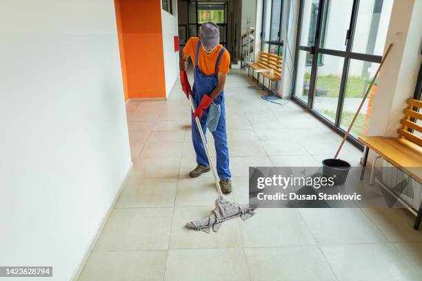 senior adult janitor cleaning floor at school - school caretaker stock pictures, royalty-free photos & images