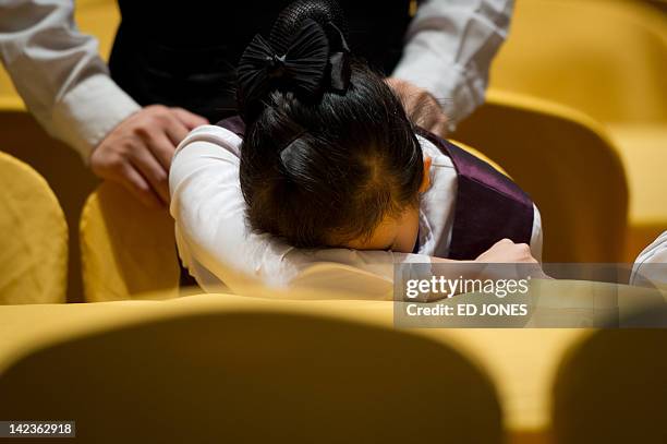 Worker sleeps inside the BFA Hotel venue during the Boao Forum for Asia, on the southern Chinese island of Hainan on April 3, 2012. The annual Boao...