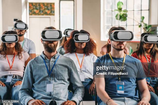 group of people wearing virtual reality vr glasses during a virtual meeting - vr goggles business stockfoto's en -beelden