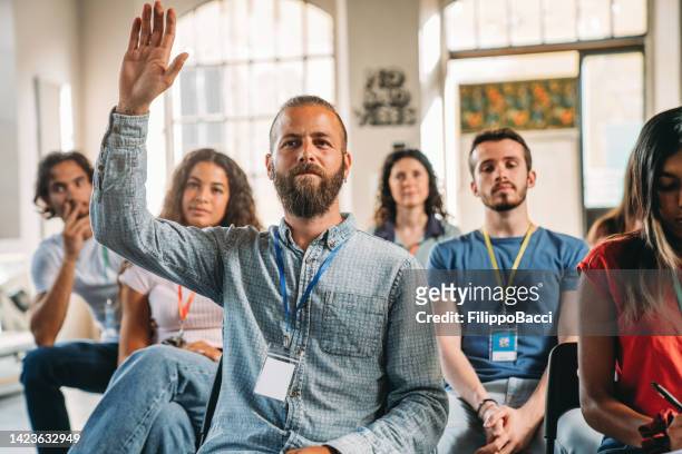 group of people sitting during a meeting - employee feedback stock pictures, royalty-free photos & images