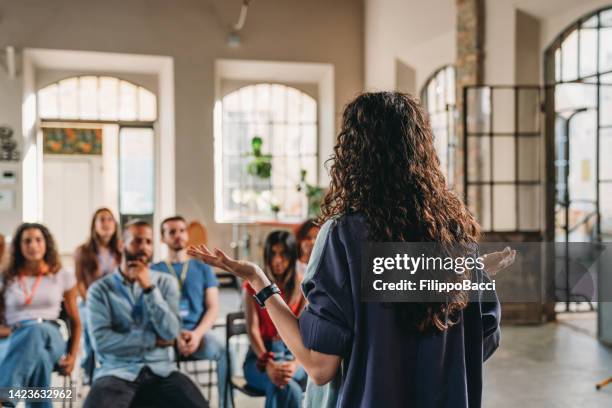 group of people sitting during a meeting - employee badge stock pictures, royalty-free photos & images