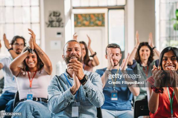 people are applauding during a conference - employee badge stock pictures, royalty-free photos & images