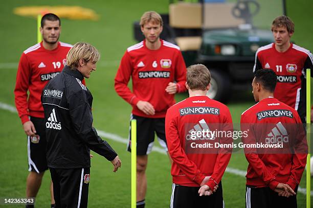 Interim coach Sami Hyypia of Leverkusen talks to his players during a training session at the Bayer 04 Leverkusen training ground on April 3, 2012 in...