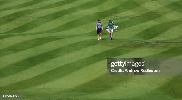 Luke Donald of England walks with his caddie Johnny 'Long Socks' McLaren during the Pro Am event prior to the start of the DS Automobiles Italian...