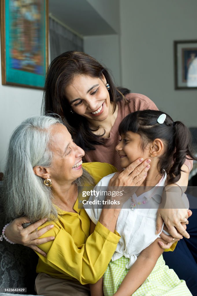 Happy woman with grandmother embracing granddaughter