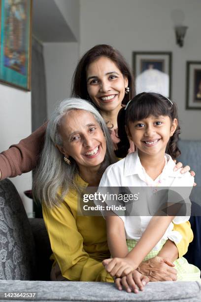 happy woman with grandmother embracing granddaughter - indian grandparents stock pictures, royalty-free photos & images