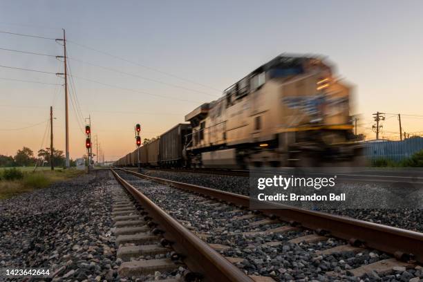 Freight train travels through Houston on September 14, 2022 in Houston, Texas. Railroads across the country are cutting shipments and Amtrak has...